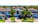Aerial view of the home in a beautiful community with manicured lawns and paver driveways at 10680 Royal Cypress Way, Orlando, FL 32836