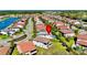 Aerial view of the community highlighting a lake, streets, and manicured green lawns at 10680 Royal Cypress Way, Orlando, FL 32836