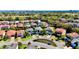 Aerial view of a neighborhood featuring landscaped cul-de-sacs, paver driveways, and lush green lawns at 10680 Royal Cypress Way, Orlando, FL 32836