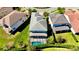 Aerial view of the home showcasing the pool, screened-in patio, and well-maintained green lawn at 10680 Royal Cypress Way, Orlando, FL 32836