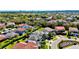 An aerial view of a community neighborhood, with various houses, lush greenery, and palm trees at 10680 Royal Cypress Way, Orlando, FL 32836