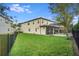 Spacious backyard with a pool and screened enclosure at 10680 Royal Cypress Way, Orlando, FL 32836