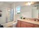 Bathroom with granite countertop, double vanity, and a glass shower at 10680 Royal Cypress Way, Orlando, FL 32836