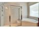 Clean bathroom with a walk-in shower, soaking tub and updated fixtures at 10680 Royal Cypress Way, Orlando, FL 32836