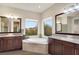 Bathroom features a large soaking tub and double vanity at 10680 Royal Cypress Way, Orlando, FL 32836