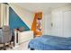 Bedroom with blue and orange accent walls, and a large closet at 10680 Royal Cypress Way, Orlando, FL 32836
