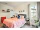 Pink bedroom with a hanging chair and a white brick accent wall at 10680 Royal Cypress Way, Orlando, FL 32836
