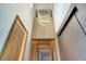 Elegant entryway featuring a unique light fixture and wood paneling at 10680 Royal Cypress Way, Orlando, FL 32836