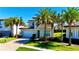 Beautiful two-story home with brick paver driveway, two-car garage, stone accents, and tropical palm trees at 10680 Royal Cypress Way, Orlando, FL 32836