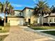 Two-story house with paver driveway and palm trees at 10680 Royal Cypress Way, Orlando, FL 32836