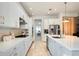 Open concept kitchen boasting white cabinets and a large island at 10680 Royal Cypress Way, Orlando, FL 32836
