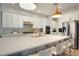 Bright kitchen with white cabinets, quartz countertops, and stainless steel appliances at 10680 Royal Cypress Way, Orlando, FL 32836