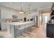 Spacious kitchen featuring white cabinets and a large island at 10680 Royal Cypress Way, Orlando, FL 32836