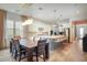 Open kitchen and dining area with modern light fixtures at 10680 Royal Cypress Way, Orlando, FL 32836