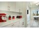 Kitchen counter with red and white appliances at 10680 Royal Cypress Way, Orlando, FL 32836