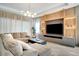 Modern living room featuring a built-in entertainment center and large sectional sofa at 10680 Royal Cypress Way, Orlando, FL 32836