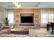 Bright living room with a stylish media wall and comfortable seating at 10680 Royal Cypress Way, Orlando, FL 32836
