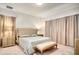 Large main bedroom with a king-size bed, neutral decor and ample natural light at 10680 Royal Cypress Way, Orlando, FL 32836