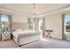 Main bedroom boasts a king-size bed and elegant chandelier at 10680 Royal Cypress Way, Orlando, FL 32836