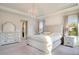 Main bedroom with king bed, dresser and large windows at 10680 Royal Cypress Way, Orlando, FL 32836