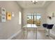 Home office with a view, white table and blue chairs at 10680 Royal Cypress Way, Orlando, FL 32836