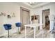 Home office with white table, blue chairs, and chevron wallpaper at 10680 Royal Cypress Way, Orlando, FL 32836