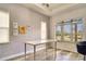 Home office featuring a large window and brick-look wall at 10680 Royal Cypress Way, Orlando, FL 32836