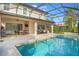 Resort-style pool with spacious patio and dining area at 10680 Royal Cypress Way, Orlando, FL 32836