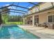 Large pool with covered patio and outdoor furniture at 10680 Royal Cypress Way, Orlando, FL 32836