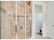 Large walk-in shower with glass enclosure and modern fixtures at 10680 Royal Cypress Way, Orlando, FL 32836
