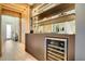 Modern wet bar with wine cooler and stylish shelving at 10680 Royal Cypress Way, Orlando, FL 32836