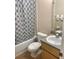 Clean bathroom with a shower/tub combination, toilet and vanity with granite countertop at 1128 S Beach Cir, Kissimmee, FL 34746