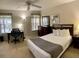 Spacious bedroom with a queen bed, a home office space, and ample natural light at 1128 S Beach Cir, Kissimmee, FL 34746