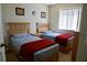 Twin bedroom with two beds, nightstands, and cheerful bedding at 1128 S Beach Cir, Kissimmee, FL 34746