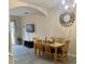 Bright dining room with a wooden table, six chairs, and a large clock on the wall at 1128 S Beach Cir, Kissimmee, FL 34746