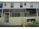 Back exterior view showing sliding glass doors and AC unit at 1128 S Beach Cir, Kissimmee, FL 34746