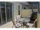 Covered patio with table and chairs, perfect for outdoor dining at 1128 S Beach Cir, Kissimmee, FL 34746