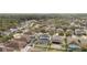 Aerial view of a house with a pool and screened enclosure, surrounded by other homes at 11412 Chateaubriand Ave, Orlando, FL 32836