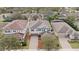 Aerial view of a two-story house with a red mulch driveway, surrounded by other houses at 11412 Chateaubriand Ave, Orlando, FL 32836