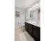 Bathroom with dark vanity and a toilet at 11412 Chateaubriand Ave, Orlando, FL 32836