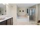 Elegant bathroom with a soaking tub, double vanity, and walk-in shower at 11412 Chateaubriand Ave, Orlando, FL 32836