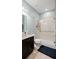 Bathroom with walk in shower,grab bars and tiled walls at 11412 Chateaubriand Ave, Orlando, FL 32836