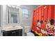 Clean bathroom with a Mickey Mouse shower curtain at 11412 Chateaubriand Ave, Orlando, FL 32836