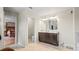 Bathroom with double vanity, a toilet and access to the main bedroom at 11412 Chateaubriand Ave, Orlando, FL 32836
