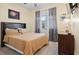 Bedroom with double bed, dresser and large window at 11412 Chateaubriand Ave, Orlando, FL 32836