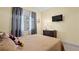 Bedroom with double bed, dresser, and window coverings at 11412 Chateaubriand Ave, Orlando, FL 32836