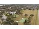 Aerial view of a community park with a pool, putting green, and open green space at 11412 Chateaubriand Ave, Orlando, FL 32836