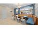 Open concept dining area with a built-in bench and a large wooden table at 11412 Chateaubriand Ave, Orlando, FL 32836