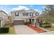 Two-story house with a brown garage door and landscaped yard at 11412 Chateaubriand Ave, Orlando, FL 32836