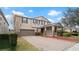 Two-story house with a brown garage door and landscaped yard at 11412 Chateaubriand Ave, Orlando, FL 32836